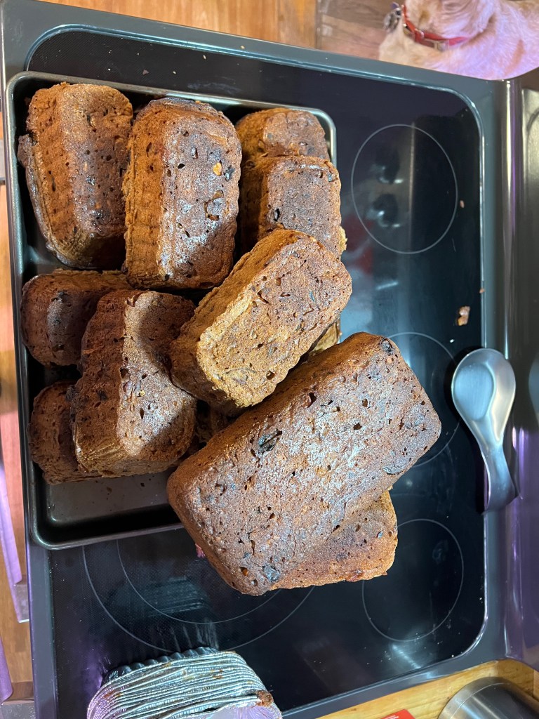 A tray of brown, rectangular baked goods stacked together on a stovetop.