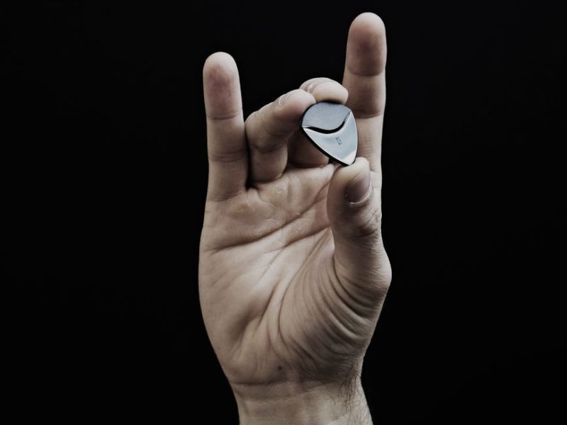 close up photo of guitar pick on person s hand